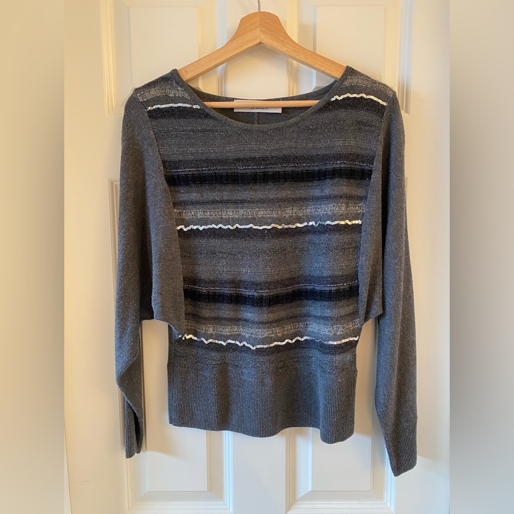 Trina Turk grey knit sweater with festive black and silver sequin stripes.